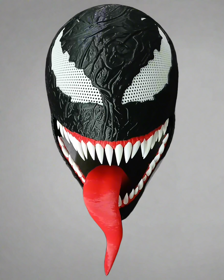 Symbiote-inspired mask shown with black textured face, white eye areas and teeth, and a long red tongue against gray.