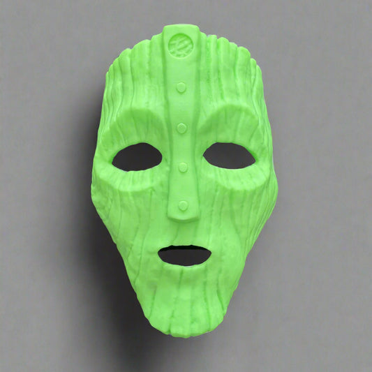 Green movie-inspired 3D printed mask with textured surface, eye and mouth openings, against a gray background.