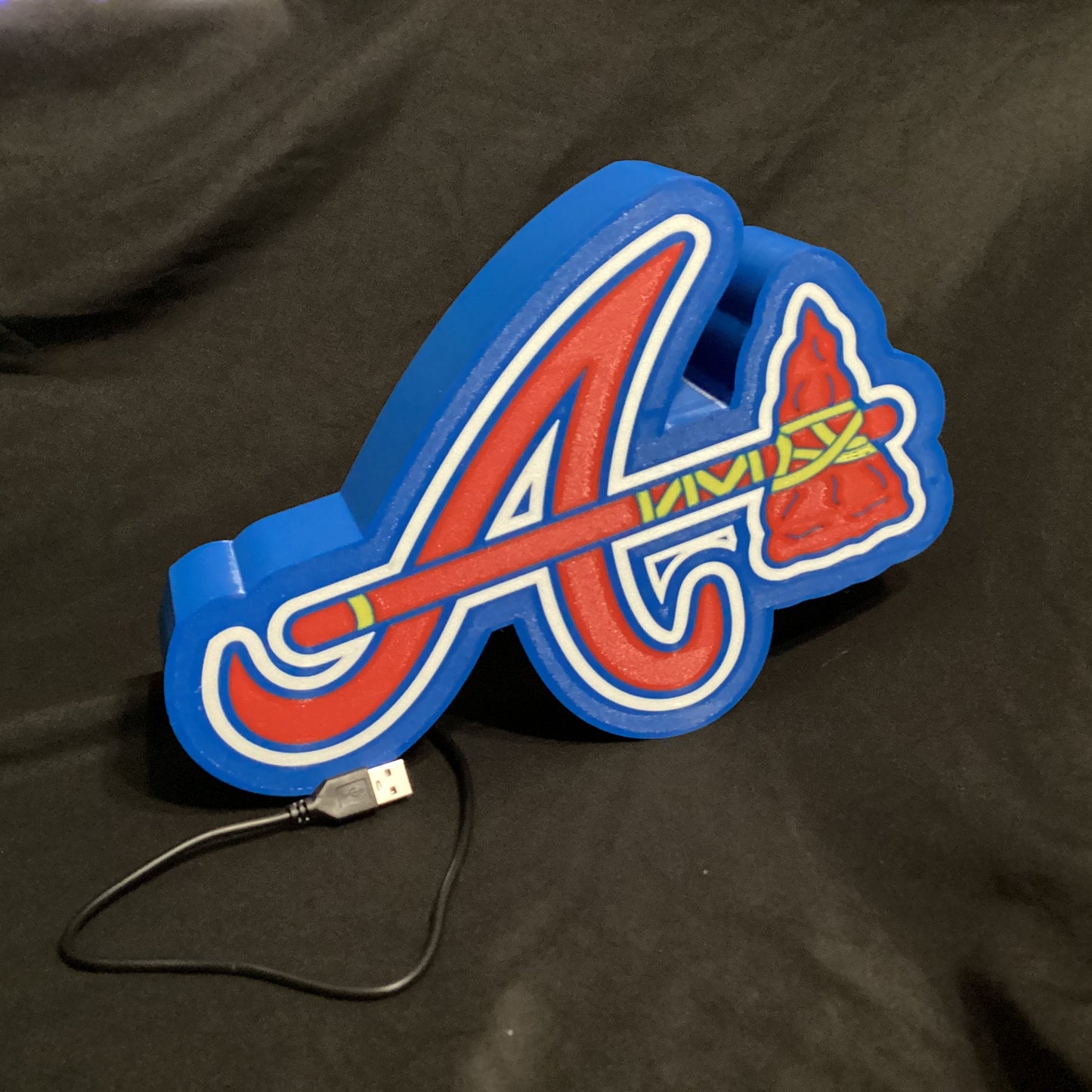 Colorful logo with a USB cable on a black background