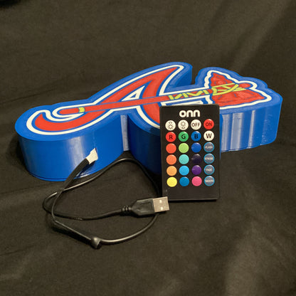 Colorful LED letter 'A' with remote control on a dark background