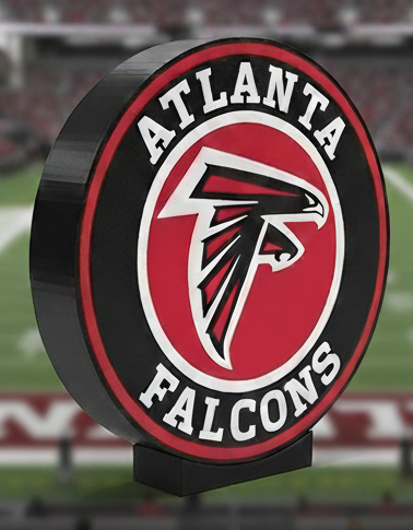 Atlanta Falcons logo in front of a blurred stadium background