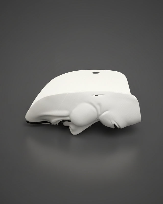 White electronic device on a gray bedspread