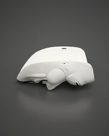 White electronic device on a gray bedspread