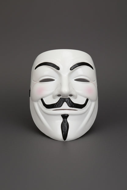 White mask with black accents on a gray surface